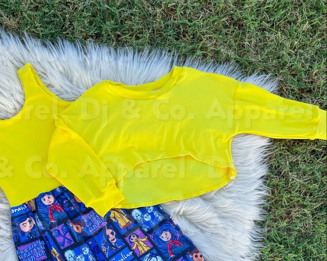 Yellow top and blue pants with character print on a fluffy white rug, branded 'DJ & Co. Apparel'.